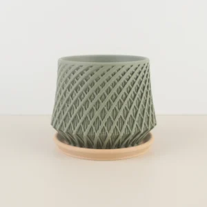 The 3DChicPot Kairo Industrial Planter showcases a dual-texture design: vertical ribs (upper) and diamond lattice (lower) for depth. Its clean, detailed look shines from afar andup-close. Perfect for modern/gallery-inspired spaces, it includes a saucer to protect surfaces.
